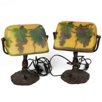 Two vintage metal desk lamps with Galle glass style shades decorated with grapes and vines, the c...