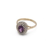 Amethyst and diamond 9ct gold cluster ring, the oval cut enclosed by sixteen small diamonds, fing...