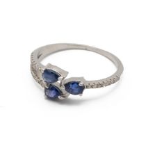 Three stone sapphire and diamond dress ring, the three pendeloque cut stones with lines of small ...