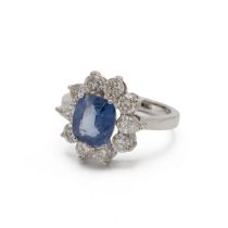 Sapphire and diamond cluster ring, the native cut stone enclosed by eight brilliant cuts and two ...