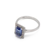 Tanzanite and diamond cluster ring, the step cut stone estimated as weighing approximately 1.4ct,...