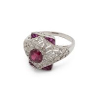 Ruby, calibre cut ruby and diamond ring, of almost bombe design, with calibre cut stones to the c...