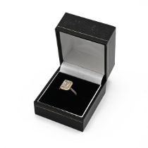 An 18ct yellow gold and diamond ring, set with a mixed step cut diamond, approximately 7.88 x 5.4...