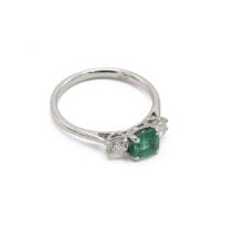 Emerald and diamond three stone ring, the square cut stone flanked either side by a brilliant cut...