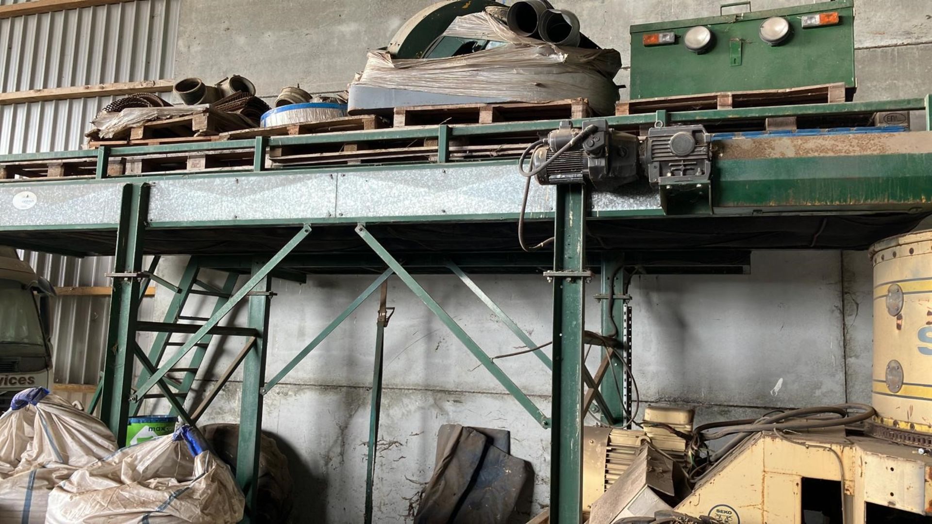 Bale Conveyor -1.25 metre wide straw bale conveyor on supporting steelwork. The conveyor is 6 metres
