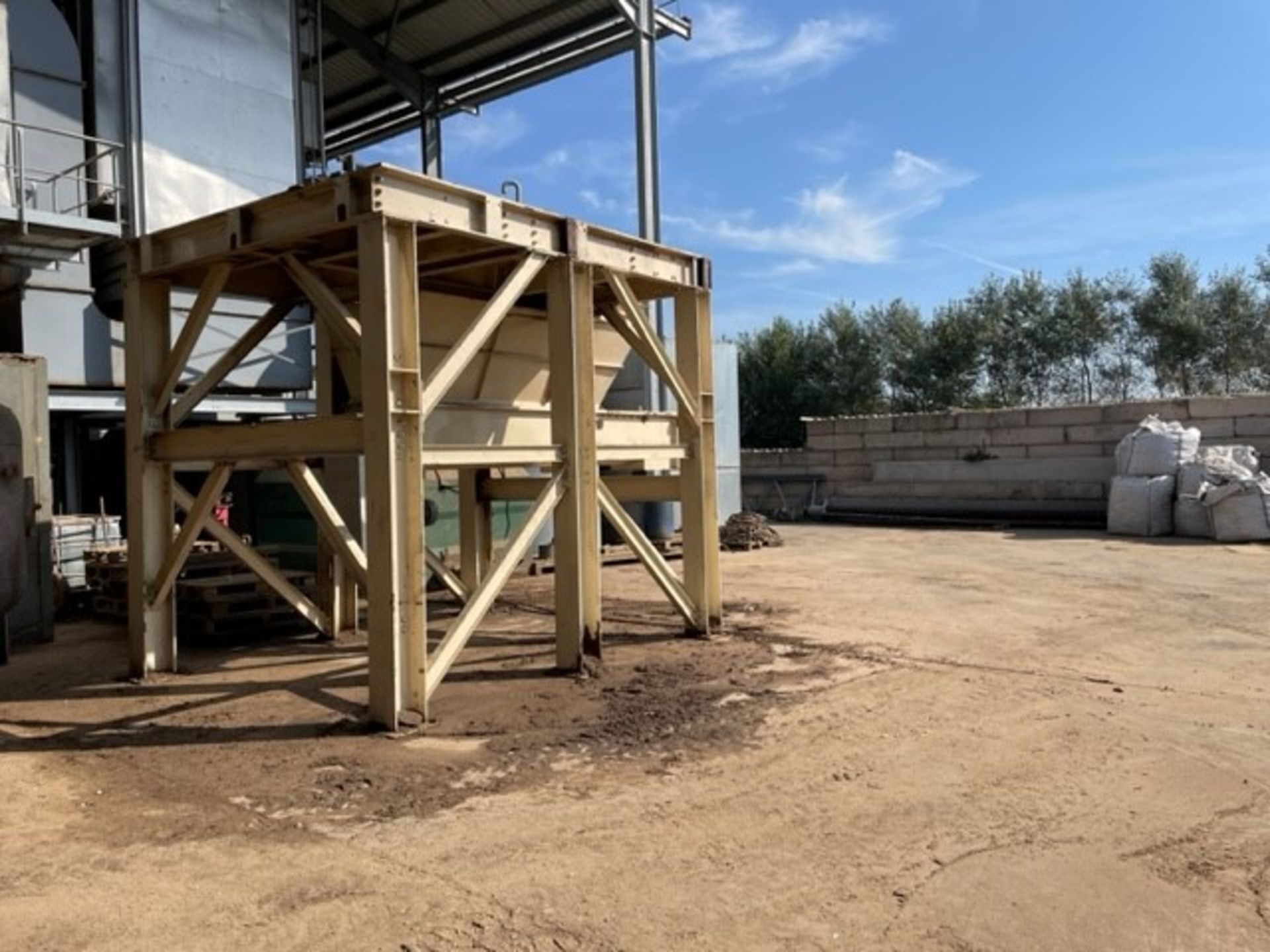 Hopper, with supporting steelwork and screw dischargers. May have been used as hammer mill under