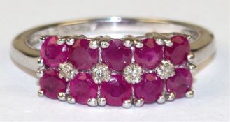 Ring, 925er Silber, besetzt mit 10 rund facettierten Rubinen und 4 kl. Diamanten, RG 53,5