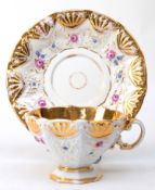 Meissen-Tasse mit UT, 19. Jh., reliefierter goldener Muschelrand und polychromer Floraldekor, stark