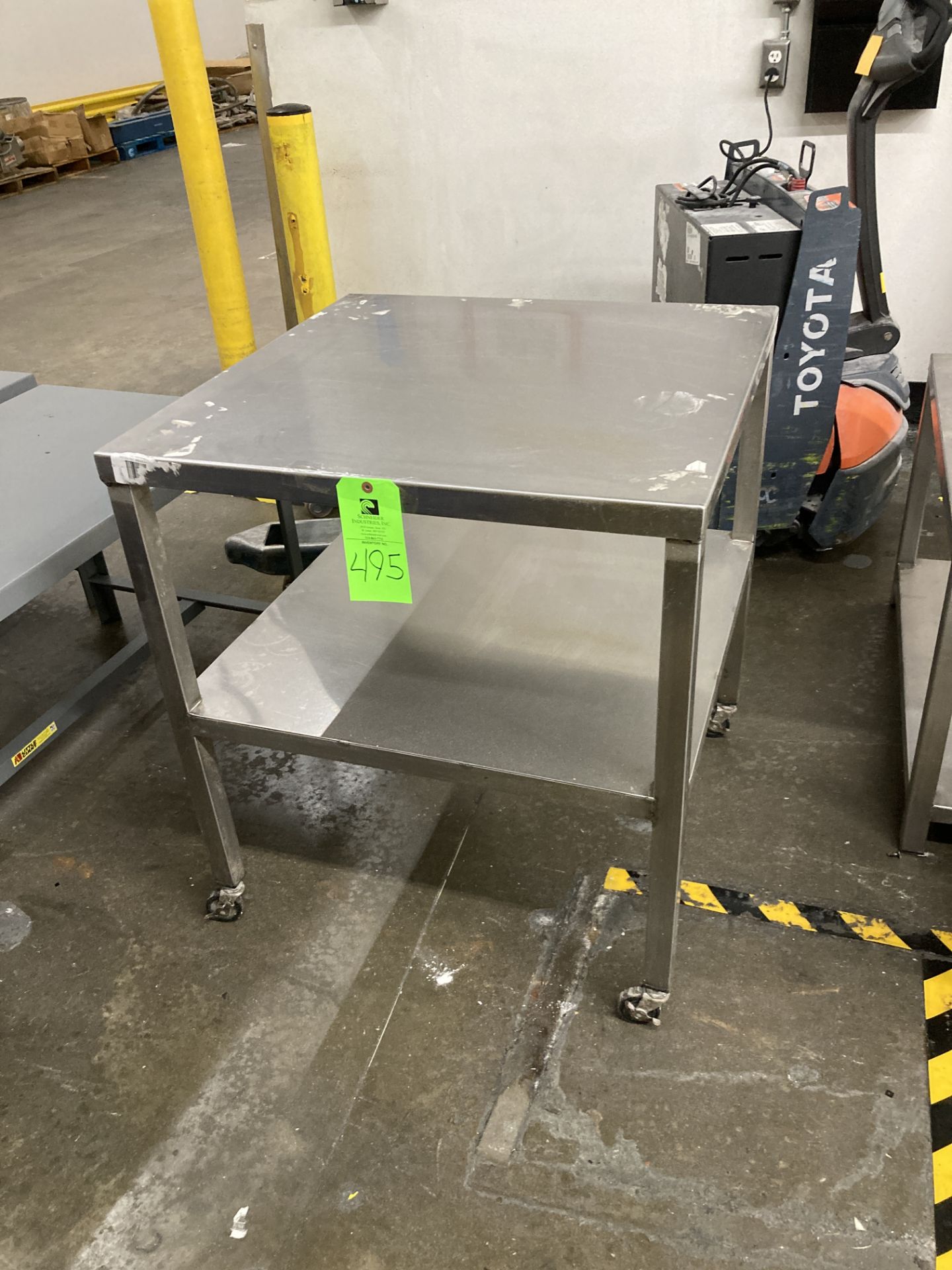 Stainless steel table with caster, 30 in x 30 in x 34 in h Rigging Fee: $ 35