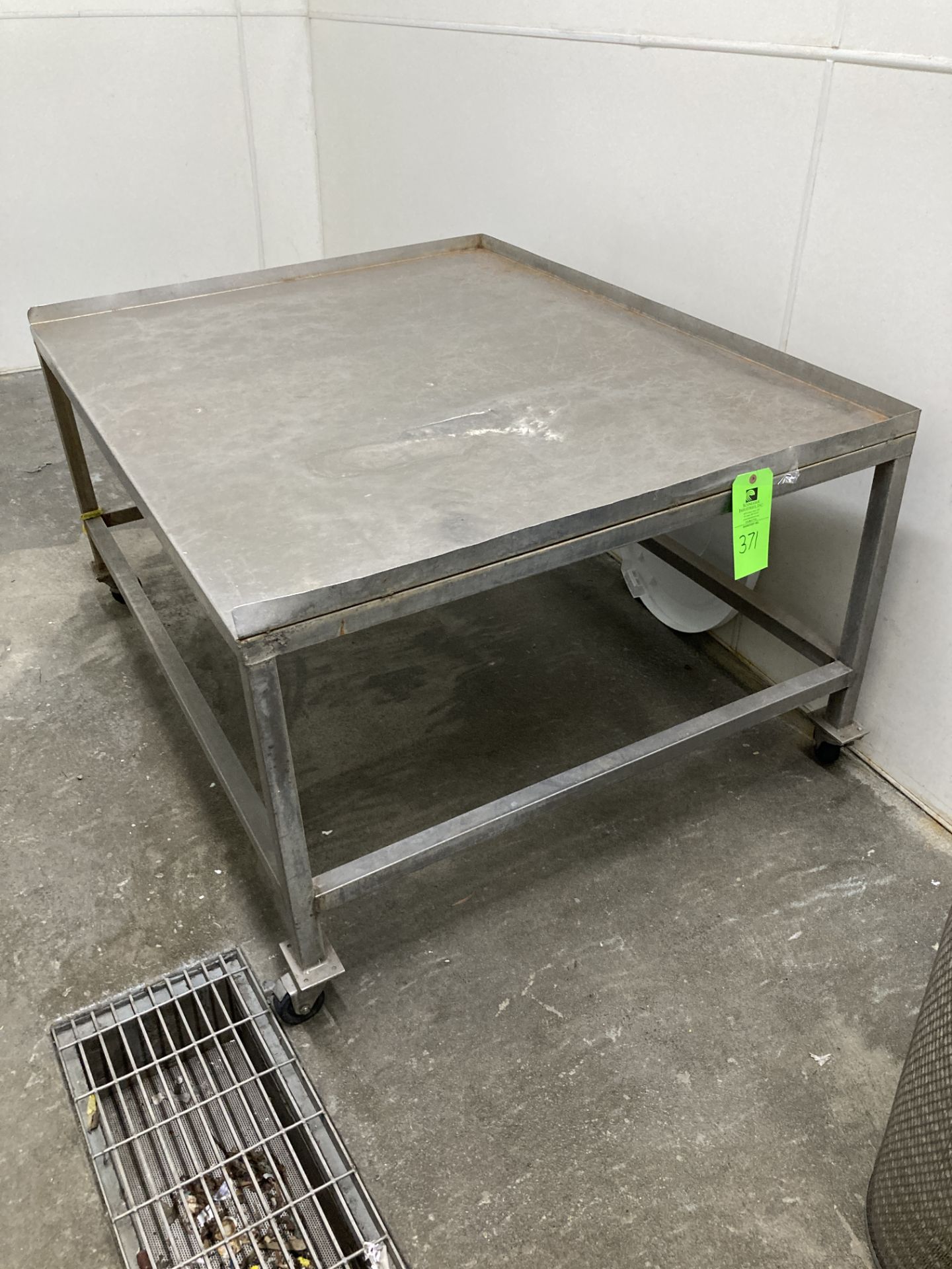 Stainless steel table with caster, 46 in x 57 in x 29 in h Rigging Fee: $ 75