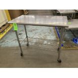 Stainless steel table with caster, 46 in x 24 in x 40 in h Rigging Fee: $ 35