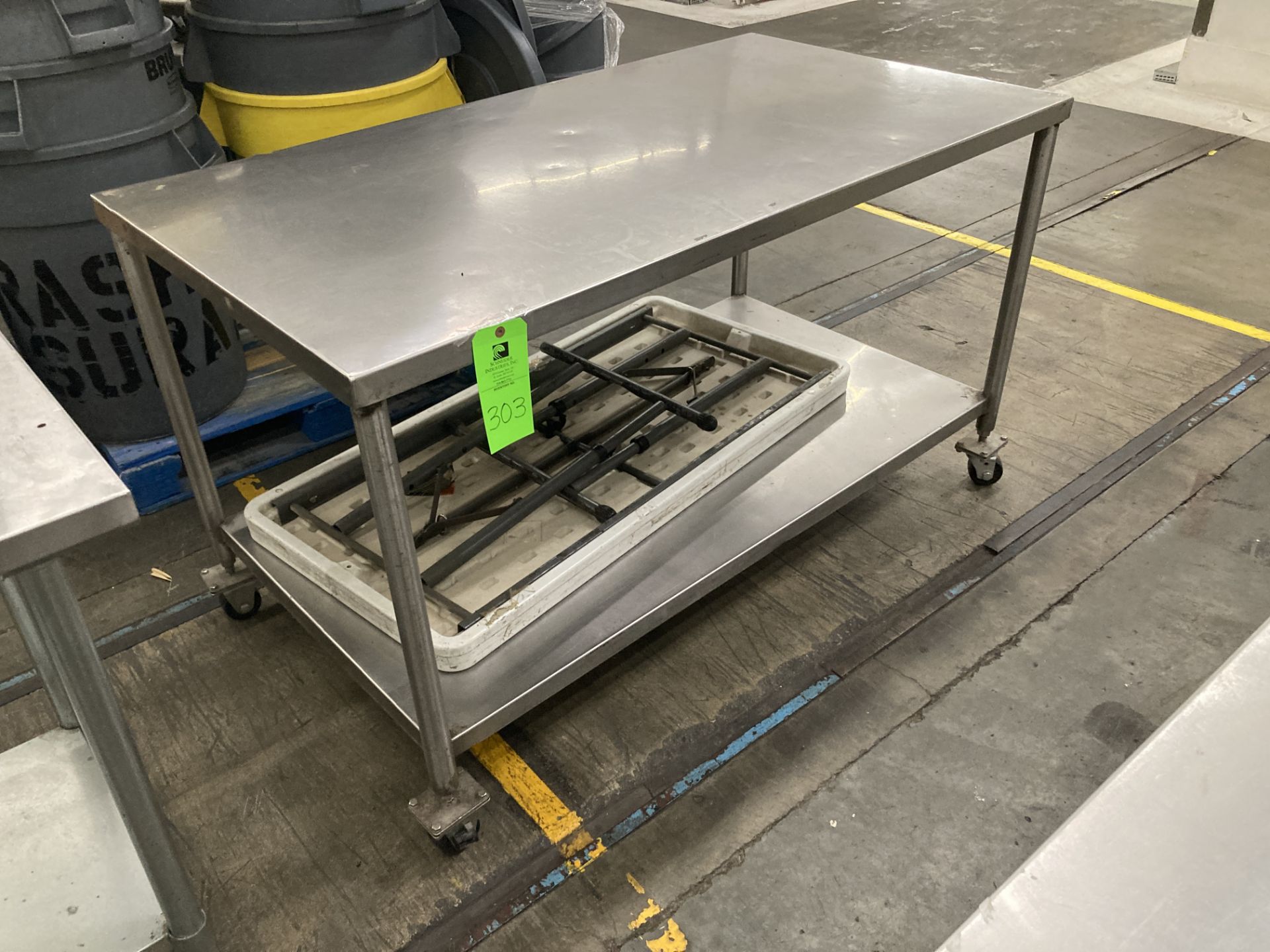 Stainless steel table with caster, 60 in x 30 in x 35 in h Rigging Fee: $ 35