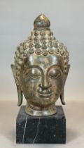 Large metal Buddha head on a marble base. Thailand.