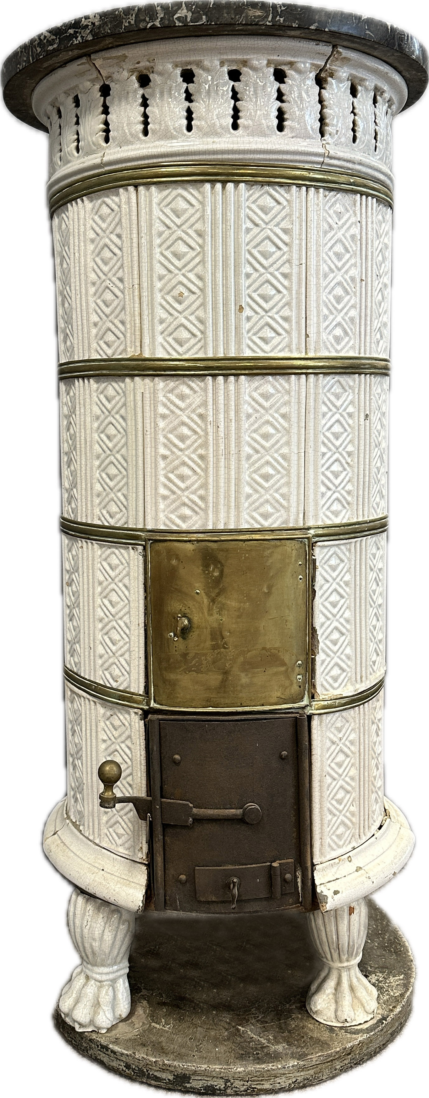 White Biedermeier round stove with tiles in relief structure.