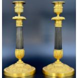 A pair of richly decorated Empire candlesticks. France. 19th century.