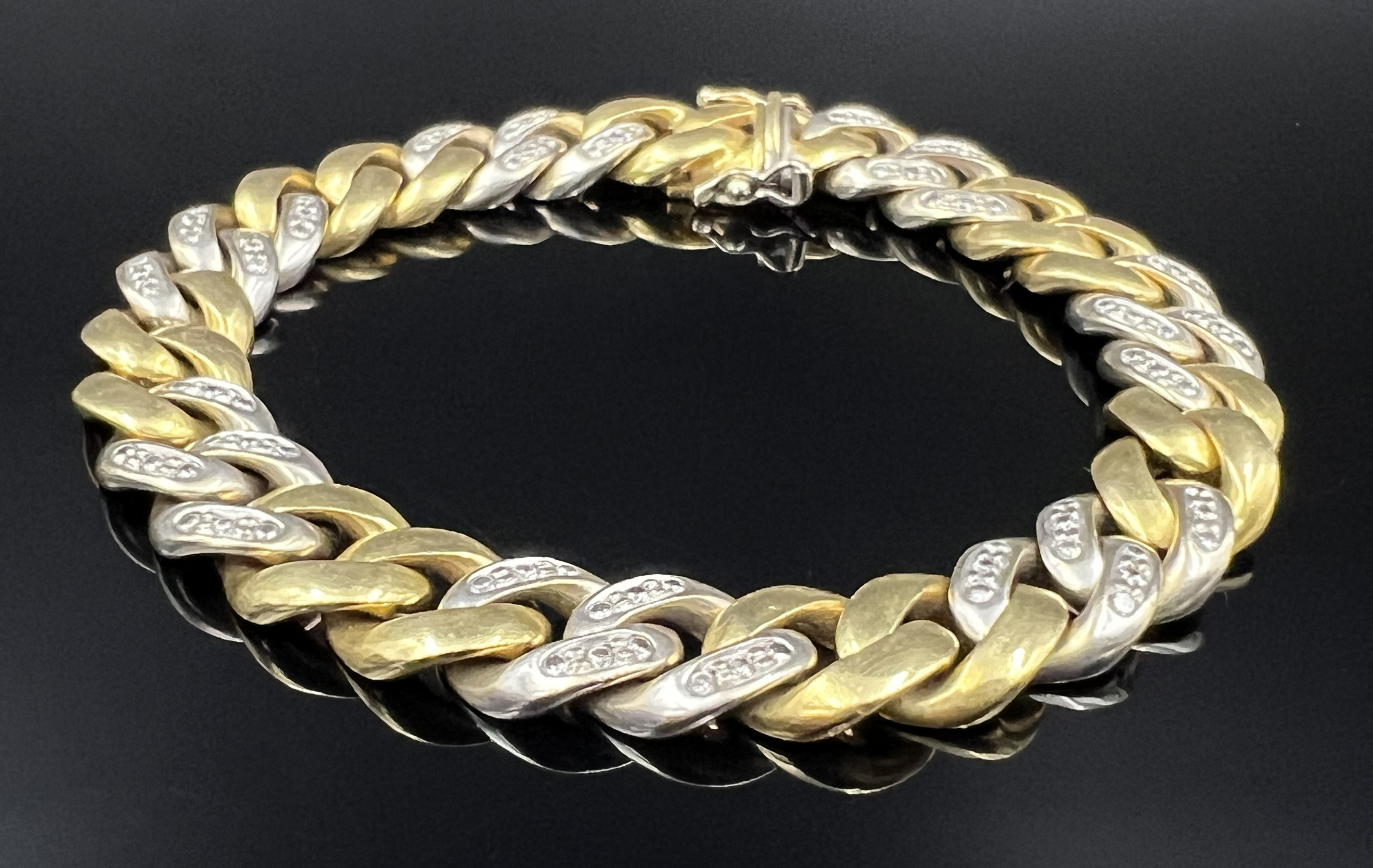 Arm chain / curb chain. 750 yellow gold and white gold with small diamonds.