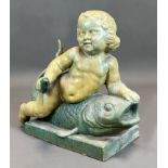 Majolica figure. Putto on a fish. Early 20th century.