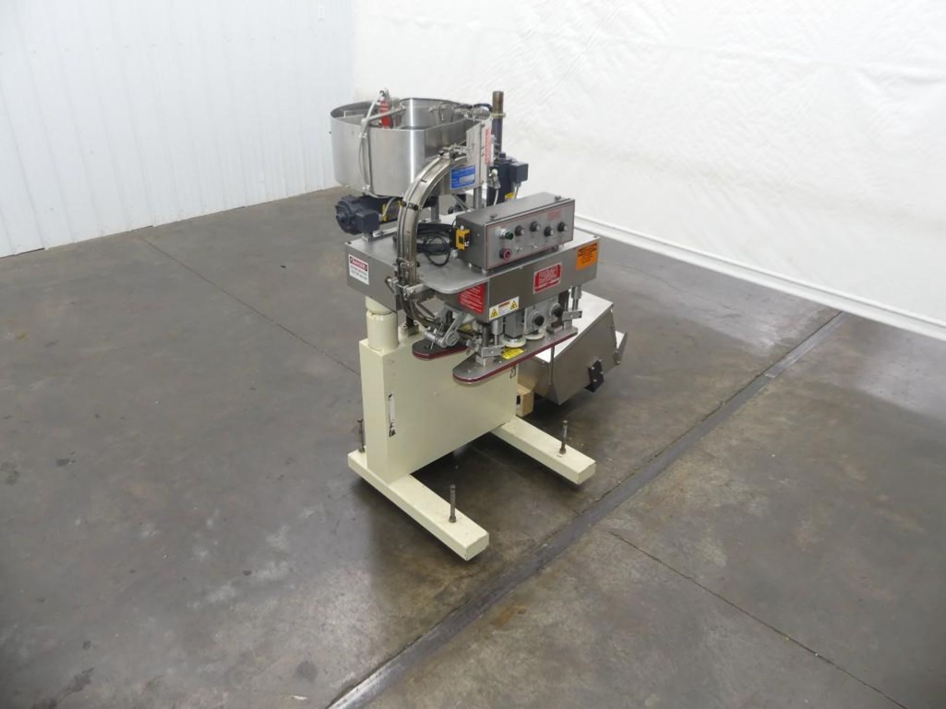 Kaps-All Model E4 Spindle Capper with a Feed Systems FSRF-24 Cap Feeder