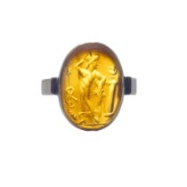 A Roman pale carnelian intaglio of a male figure, mounted in an early 20th Century gold ring