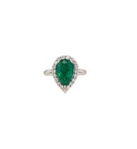 A pear shaped emerald and diamond cluster ring