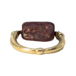 An ancient jasper Babylonian three sided swivel seal set in a 19th Century gold snake ring