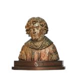 British, 16th Century, A carved walnut and polychrome bust of a saint