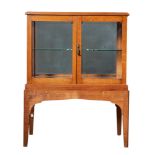 British, 20th Century, An oak glazed cabinet on stand