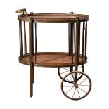 Circa 1930, An oak and brass wheeled serving trolley