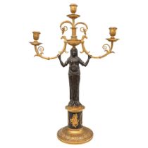 French Empire, A pair of patinated brass and ormolu figural candlesticks