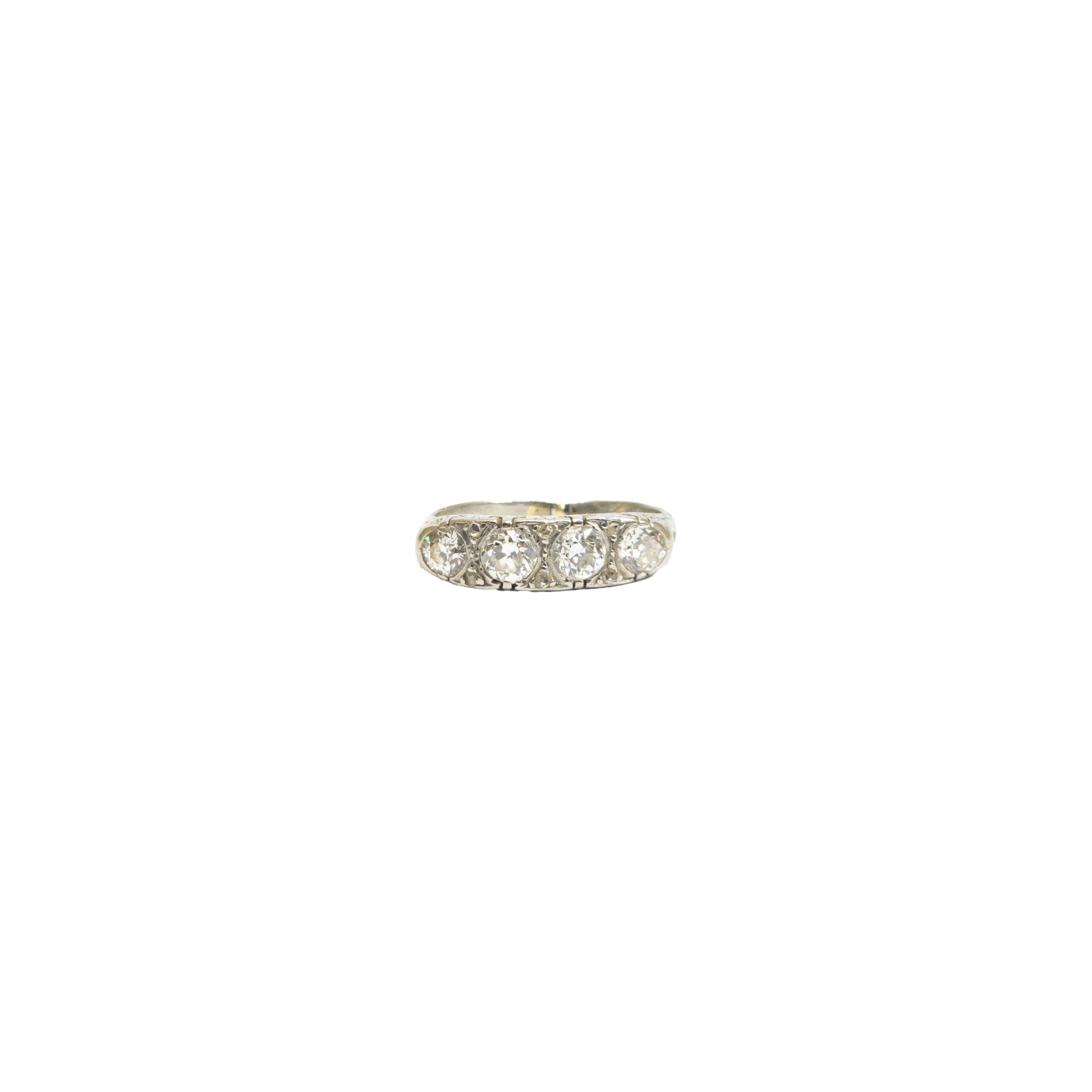 British, Late 19th Century, A four stone diamond and platinum half hoop ring