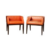 Contemporary, A pair of ebonised wood and leather upholstered chairs