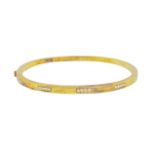 British, Circa 1980, A diamond and 18 carat yellow gold bangle