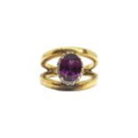 British, Circa 1980, A diamond, red stone and 9 carat yellow gold dress ring