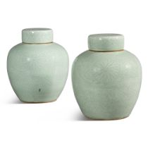 A pair of carved celadon-glazed 'lotus' jars and covers, Qing dynasty, Kangxi period