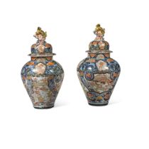 A pair of Japanese Imari vases and covers and a third ensuite with associated cover, Edo period,