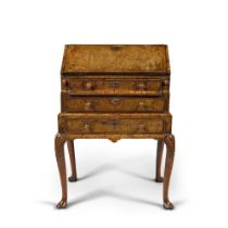 A George II Figured Walnut Bureau on Stand, Circa 1730