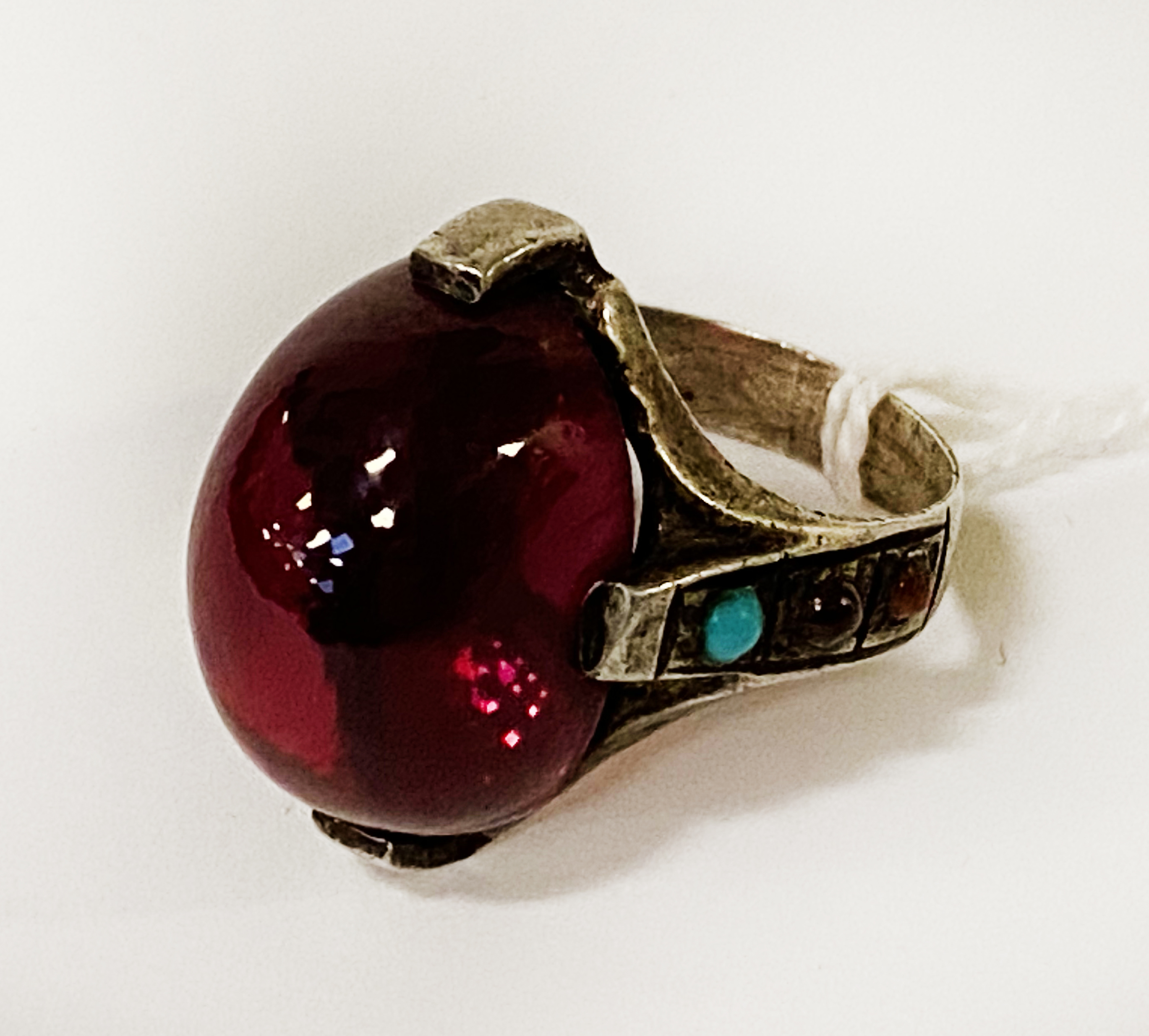ANTIQUE IRANIAN SILVER & CABACHON RUBY RING WITH TURQUOISE & OTHER SEMI-PRECIOUS STONES TO THE