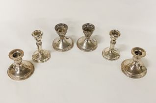 THREE PAIRS OF STERLING WEIGHTED CANDLESTICKS