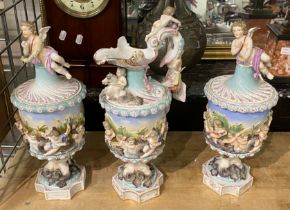 THREE DRESDEN URN TRIO LIDDED FOOTED CUPIDS - A/F