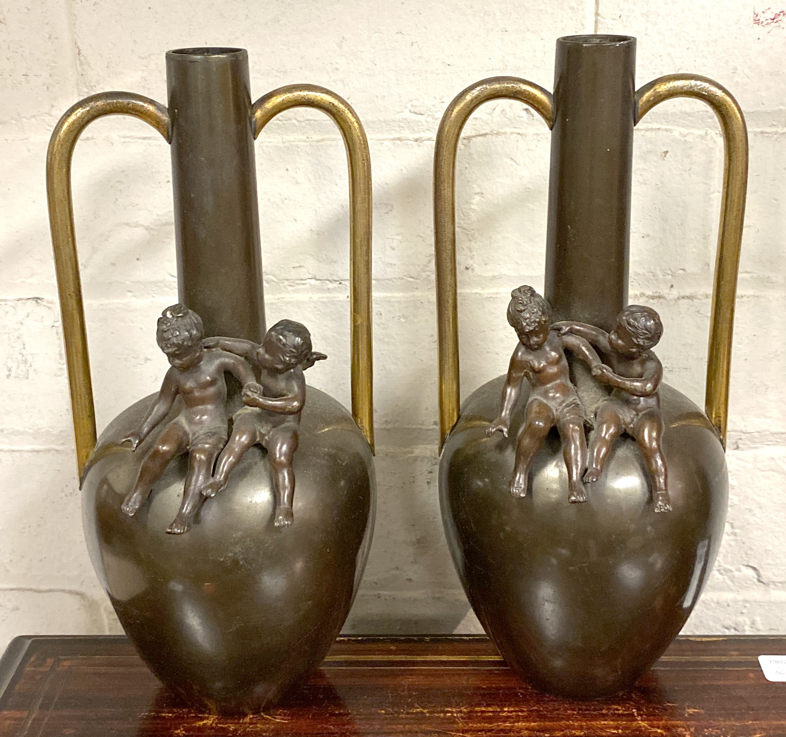 PAIR OF BRONZE VASES WITH CHERUBS - 26 CMS (H) APPROX