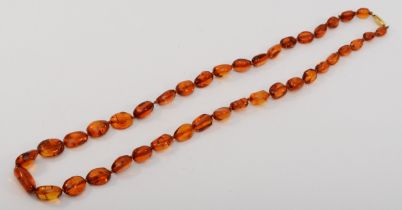 A 375 gold clasped graduating Baltic amber beaded necklace, 9 - 20mm beads, 22.4gm.