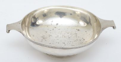 A silver porringer, Chester 1938, with ribbed border, 15.5cm across the handles, 135gm
