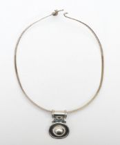 Silvarious, a silver modernist pendant 38 x 28mm, on a torque necklace, 37gm.