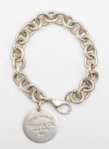 Tiffany & Co, a silver identity bracelet with round tag, 18cm, 36gm.