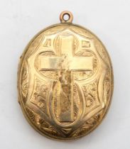 An unmarked gold front and backed oval locket, with foliate and cross chased decoration, 38 x