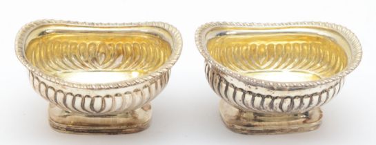 A George III silver pair of salts, London 1816, with ribbed bodies and gadrooned borders, 9.5 x 8