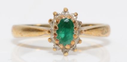 A 9ct gold emerald and diamond cluster ring, I, 1.8gm.