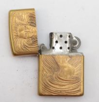 Zippo, a brass petrol lighter with a long haired lady and H D.