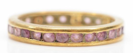 A 9k gold pink sapphire full eternity ring, S, 2.6gm.