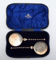 A silver pair of serving spoons, London 1911, crested, 19cm, 99gm, cased